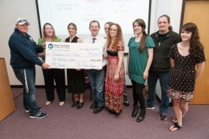 Phi Theta Kappa students with giant check