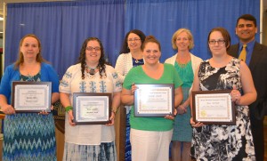 A group of students with their awards with staff