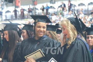 Graduates laughing during commencement ceremony