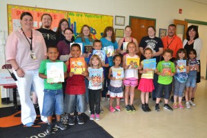 Otaku club presenting book donations to a group of children