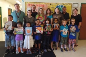 Following another successful club fundraiser, the Otaku United club at Mount Wachusett Community College donated more than 1,000 books to Waterford Street School children. Pictured in the back row behind the elementary school students, from left: Waterford Street School Principal Daniel Hill, Heather Chandry (club president);Jonathan Cohen (vice president); Rebekah Cohen (treasurer); Andrea Bartlett (auction coordinator); Cassandra Cohen (secretary); first grade teacher Peter Pianka; and Assistant Principal Melissa McDonald.