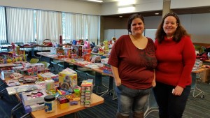 Parent Support President and Student Michel Cocuzza and PSG Club Advisor Ann Reynolds stand in front of tables of donations gathered in the North Café at Mount Wachusett Community College Monday.