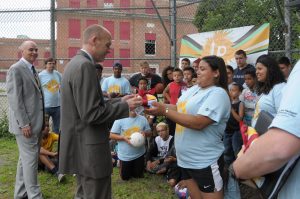 Students giving President Vander Hooven a shirt