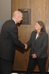 President Vander Hooven shaking Claire Freda's hand