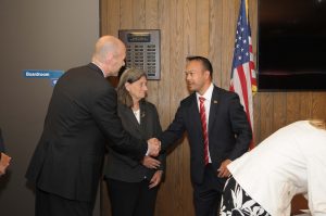 President Vander Hooven shaking Dean Tran's hand