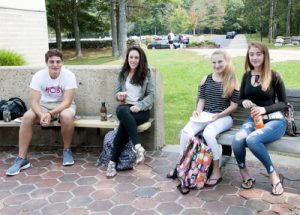 Four students sitting in the courtyard